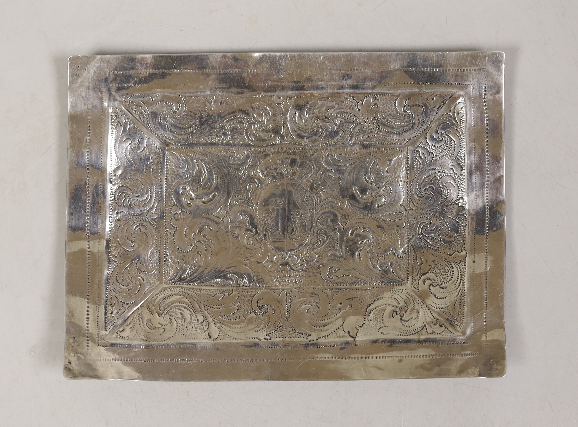 An 18th century? Italian white metal rectangular plaque, engraved with scrolls and central armorial, Rome mark, 14.7cm, 53 grams.